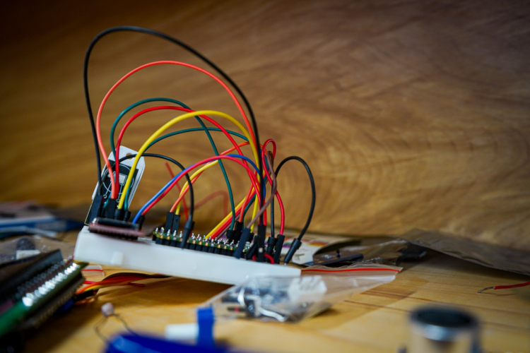 A closeup of multi-colored wires plugged into a small panel