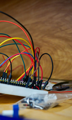 A closeup of multi-colored wires plugged into a small panel